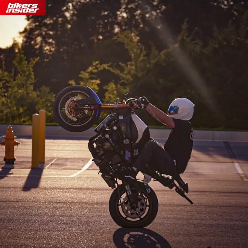 A rider doing a wheelie while wearing Icon Airframe Pro.